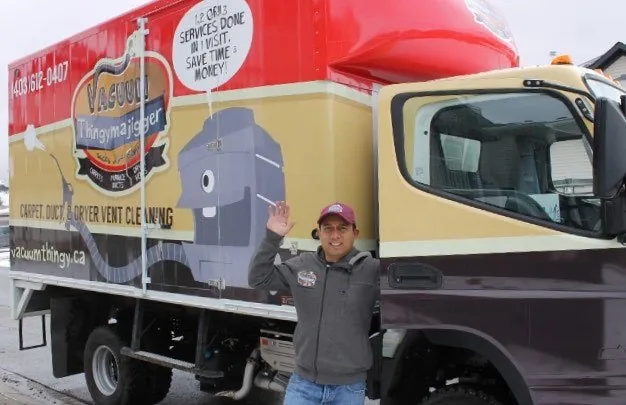 Owner Carlito Pozon standing beside the Vacuum Thingymajigger truck