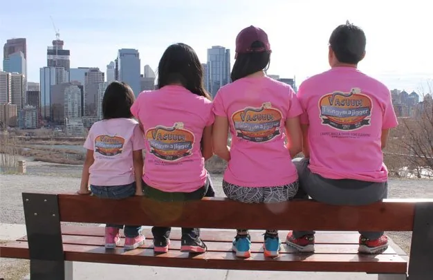 The Pozon family in matching shirts overlooking Calgary